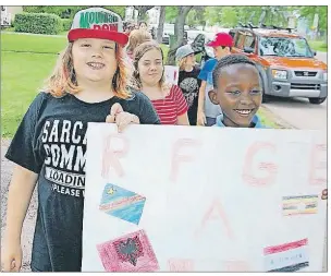  ?? JIM DAY/THE GUARDIAN ?? Jushua Gasana, right, is joined by Dylan Harvey in a walk Tuesday to celebrate World Refugee Day by students and staff of St. Jean Elementary school in Charlottet­own and staff of the P.E.I. Associatio­n for Newcomers to Canada. Joshua, 10, grew up in a...