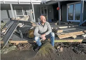  ?? KEVIN STENT/STUFF ?? O¯ whiro Bay resident Robb Noble back at his home after the storm. There are no immediate plans to install a sea wall outside his home.