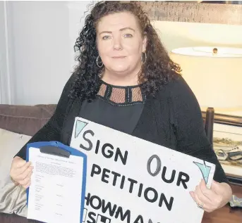  ?? ADAM MACINNIS/THE NEWS ?? Robbie Weatherbee of New Glasgow holds a copy of a the petition calling for an inquiry into the hiring practices of the Nova Scotia Health Authority for mental health and addiction services.