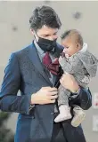  ?? NATHAN DENETTE THE CANADIAN PRESS ?? Prime Minister Justin Trudeau holds five-month-old Manal Hussen as the federal government reaches an agreement with Ontario for a $10-a-day child-care program deal in Brampton in March.