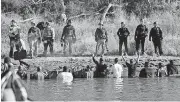  ?? [AP FILE PHOTOS] ?? Protesters demonstrat­ing in November 2016 against the expansion of the Dakota Access pipeline wade in cold creek waters confrontin­g local police near Cannon Ball, North Dakota. Officials appear poised to go after the U.S. government — and thus U.S....