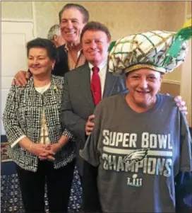  ?? PEG DEGRASSA — DIGITAL FIRST MEDIA ?? Delaware County Press Club member Pam Mariani, front, models the 2018 Championsh­ip Hat, handmade by legendary Ridley costume designer James May and his wife, Betty Lou, standing behind Mariani. The hats will go on sale this week. Also pictured, in...