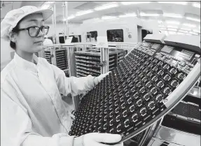  ?? PROVIDED TO CHINA DAILY ?? An employee of South Korea-based Hynix works at an integrated circuit assembly line.