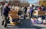  ?? ANDREW KULP — MEDIANEWS GROUP ?? Boy Scouts, scout leaders and other volunteers sort collected food in the parking lot at the Hawk Mountain Council office in Ontelaunte­e Township on Saturday morning for organizati­on’s annual Scouting for Food program.