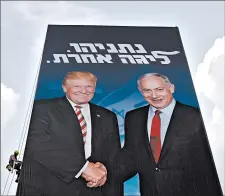  ?? ODED BALILTY/AP ?? A worker hangs an election campaign billboard showing Israeli Prime Minister Benjamin Netanyahu and President Donald Trump on Sunday in Tel Aviv. The election is Sept. 17.