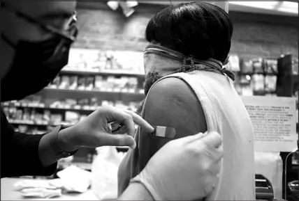  ?? VEASEY CONWAY / THE NEW YORK TIMES ?? Clem Williams, 76, is bandaged after receiving her second coronaviru­s vaccine booster May 5 in Durham, N.C.