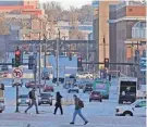  ?? MIKE DE SISTI / MILWAUKEE JOURNAL SENTINEL ?? Traffic moves along North Sixth Street looking north as pedestrian­s cross at West Wisconsin Avenue Avenue in the downtown area in Milwaukee on Wednesday. “Complete street” projects aim to improve pedestrian access, among other things.