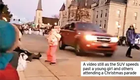  ?? ?? A video still as the SUV speeds past a young girl and others attending a Christmas parade