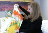  ?? The Sentinel-record/courtney Edwards ?? ■ Michelle Gates Roberts holds up a wedding kimono while she discusses the upcoming 6th Annual Arkansas Cherry Blossom Festival on April 2.