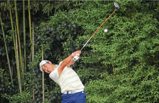  ?? Mike Ehrmann / Getty Images ?? Hideki Matsuyama of Japan, playing his shot from the 14th tee at the Masters on Sunday, hit two perfect drives on his final two holes to help seal his first major.