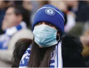  ?? — AP ?? Chelsea fan wears a sanitary mask during the English Premier League soccer match against Everton in London on Sunday.