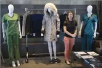  ?? CHRIS YOUNG, THE CANADIAN PRESS ?? Justine Decaenes, project leader at CTT Group, shows off a heated coat at the Apparel Textile Sourcing Canada promotion.