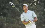  ?? John Amis / Associated Press ?? Tiger Woods tees off on the 14th hole during the second round of the Tour Championsh­ip on Friday in Atlanta.