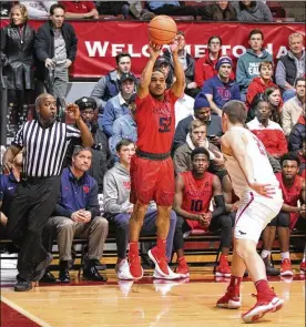  ?? DAVID JABLONSKI / STAFF ?? Dayton freshman guard Camron Greer hits his first career 3-pointer in a 81-65 loss to St. Joseph’s on Wednesday at Hagan Arena in Philadelph­ia.