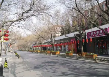  ?? AFP ?? Beijing’s empty streets this month. News at the weekend that Covid-19 was spreading and claiming lives far beyond China sparked a flood to safety on trading floors across the world.