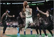  ?? CHARLES KRUPA — THE ASSOCIATED PRESS ?? Celtics forward Jayson Tatum, who scored 31points, is surrounded by a quartet of Nets players on Wednesday.