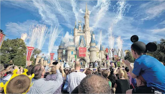  ??  ?? Fireworks go off around Cinderella’s castle during the grand opening ceremony for Walt Disney World’s new Fantasylan­d in Lake Buena Vista, Florida in 2012.