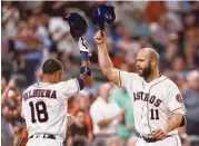  ?? Karen Warren / Houston Chronicle ?? It’s hats off as Evan Gattis, right, enjoys his homer with Luis Valbuena, who hit the go-ahead shot in the sixth.