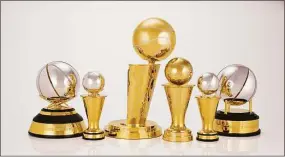  ?? Jennifer Pottheiser / Associated Press ?? This photo provided by the NBA shows a group of trophies. The NBA’s championsh­ip trophy has a new look, and the league is going to be handing out some new trophies for the first time during these playoffs. The league unveiled a redesigned Larry O’Brien Trophy on Thursday, plus announced changes to the Bill Russell NBA Finals MVP trophy and changes to the design of the conference championsh­ip trophies.