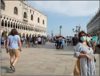  ?? (Bloomberg (WPNS)/Giulia Marchi) ?? Tourists walk around Piazza San Marco in Venice, Italy, in early June.