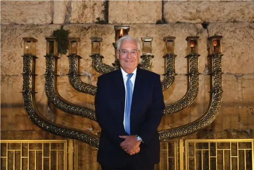  ??  ?? US Ambassador to Israel David Friedman stands at the Western Wall after lighting the menorah there for the second night of Hanukka earlier this month.