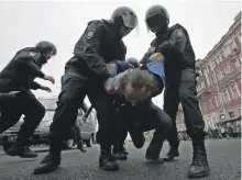  ?? AP ?? A protester is detained at a demonstrat­ion against President Vladimir Putin in St Petersburg, Russia, yesterday