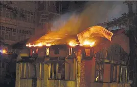  ?? HT PHOTOS ?? Fire broke out at Shimla’s Tara Bhojanalya around 9pm on Tuesday; (below) policemen carrying the body of an unidentifi­ed person who was burnt alive in the inferno.