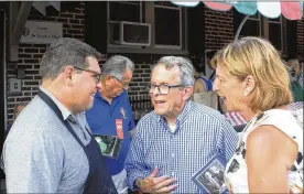  ??  ?? Mike DeWine (center) and his wife Fran talk with Matt Daniels, principal of St. Rocco Parish School at the school’s annual festival on Sept. 2.