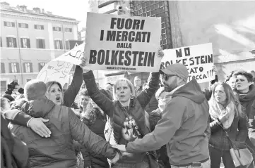  ??  ?? Street vendors hold posters reading ‘No Bolkestein’ in front of the Parliament to protest against EU directive Bolkestein in Rome, as part of a demonstrat­ion of taxi drivers and peddlers. — AFP photo