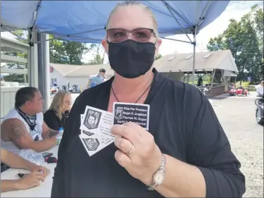  ?? MICHELLE A. LYNCH - MEDIANEWS GROUP ?? Diane Simmons of the Berks Forget-Me-Nots shows memorial cards featuring Col. Thomas W. Dugan, Capt. David E. Pannabecke­r and Lt. Col. Ralph H. Angstadt, Berks County missing servicemen honored during Aug. 30’s Ride for Freedom.