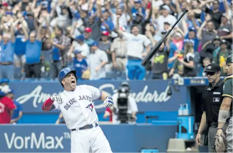  ?? MARK BLINCH/THE CANADIAN PRESS ?? Toronto’s Steve Pearce flips his bat in celebratio­n after hitting a walk-off grand slam to defeat Oakland during the 10th inning of the Blue Jays’ 8-4 win over the Athletics Thursday in Toronto.