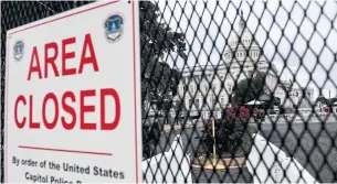  ?? OLIVIER DOULIERY AFP VIA GETTY IMAGES ?? The U.S. Capitol is seen through a temporary security fence in Washington on Friday. Security measures are heightened in preparatio­n for a demonstrat­ion Saturday.