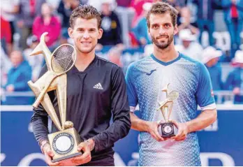  ??  ?? Dominic Thiem of Austria (L) and Albert Ramos-vinolas of Spain with their trophies after the singles final match of the Generali Open of the ATP Tour in Kitzbuehel, Austria. — AFP