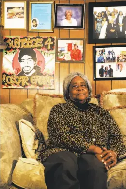  ?? Yalonda M. James / The Chronicle ?? Bonnie Johnson, Oscar Grant’s grandmothe­r, features artwork of Grant among the gallery of family photos that adorns a wall in her Hayward home. The portrayal of her grandson in his tribute mural is controvers­ial.