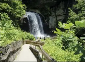  ?? HILLARY SPEED VIA AP ?? Looking Glass Falls, located in the Pisgah National Forest, between Brevard, N.C., and the Blue Ridge Parkway. Known as “The Land of the Waterfalls,” Transylvan­ia County boasts more than 250 waterfalls that attract visitors every year.