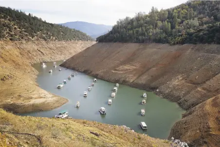  ?? Rich Pedroncell­i / Associated Press 2015 ?? Houseboats dot Oroville Lake in 2015 during California’s multiyear drought. Federal scientists anticipate a dry winter this year.