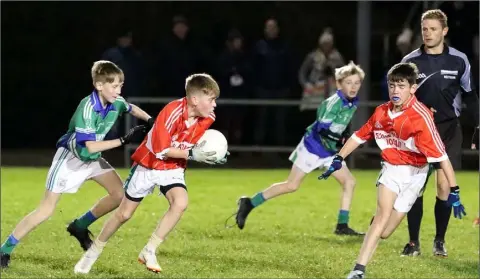  ??  ?? Tiernan Meyler of St. Joseph’s (Gorey) on the move out of defence as Glynn’s Cathal Sinnott leads the pursuit.