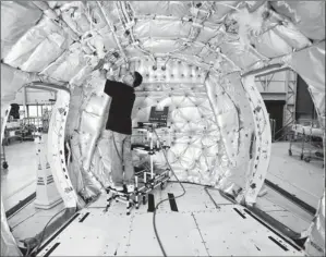  ?? By Dan Delong, Red Box Pictures, for USA TODAY ?? Popular model: Electricia­n Kyusuk Mun installs wiring in a 737 in the Renton, Wash., plant.