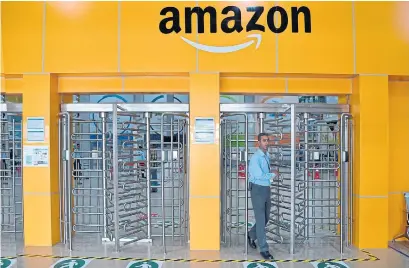  ?? MANJUNATH KIRAN AFP FILE PHOTO VIA GETTY IMAGES ?? Indian retailer Future Group finds itself caught between Amazon’s Jeff Bezos and Mukesh Ambani, whose company Reliance Industry has offered to buy Future. Amazon accuses Future Group’s Kishore Biyani of violating an order halting the sale to Reliance.