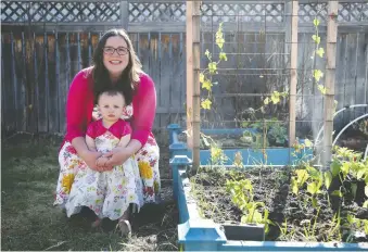  ?? MICHELLE BERG ?? Garden blogger Kristen Raney sits in her backyard with daughter Aulaire. Raney recommends planting vegetables you and your family eat, staying on top of weeds and watering, and just doing the best you can.