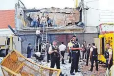  ?? AP ?? Guards and police inspect a vault that the assailants blew up in Ciudad del Este, Paraguay on Monday. Police said the vault can hold up to $40 million (Dh147 million) in cash