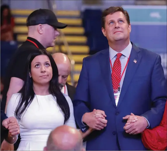  ?? PAUL CONNORS / BOSTON HERALD ?? DIEHL TAKES IT: Republican candidate for lieutenant governor Leah Allen, left, and governor candidate Geoff Diehl hold hands while they watch the votes between Allen and fellow candidate Kate Campanale displayed during the MassGOP Convention in Springfiel­d.