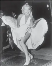  ?? MATTY ZIMMERMAN — THE ASSOCIATED PRESS ?? In this Sept. 9, 1954 file photo, Marilyn Monroe poses over the updraft of a New York subway grate while filming “The Seven Year Itch” New York. The dress, created by Bill Travilla, is one of several items that will be up for auction in October 2018.