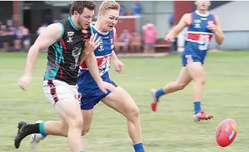  ?? ?? Cora Lynn’s Tim Payne and Bunyip’s Daniel Helmore race for possession of the ball.