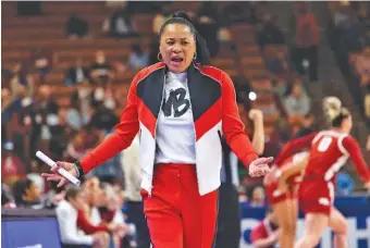  ?? AP PHOTO/MIC SMITH ?? South Carolina women’s basketball coach Dawn Staley questions an official’s call during the Gamecocks’ SEC quarterfin­al win against Arkansas on Friday in Greenville, S.C.