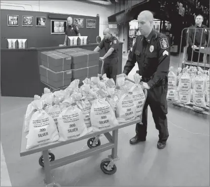  ??  ?? ARKANSAS RESIDENTS CASH IN: It’s like a modern day Gold Rush. Everyone’s scrambling to get their hands on the heavy, Jumbo Silver Ballistic Bags pictured above before they’re all gone. That’s because residents who find their zip code printed in today’s publicatio­n are cashing in on the lowest ever State Minimum price set for the next 2 days by the Federated Mint.