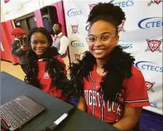  ?? Christian Abraham / Hearst Connecticu­t Media ?? Students Jessica Pobee, at left, and Ashley Roche volunteer as announcers as they take part in J.M. Wright Technical High School's Earth Day Celebratio­n and its "trashy" fashion show in the gymnasium in Stamford on Friday.