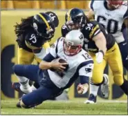  ?? THE ASSOCIATED PRESS FILE PHOTO ?? Tom Brady is sacked by Steelers linebacker­s Jarvis Jones (95) and Anthony Chickillo (56) during a game this past October.