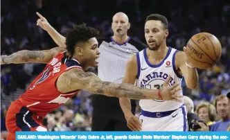  ??  ?? OAKLAND: Washington Wizards’ Kelly Oubre Jr, left, guards Golden State Warriors’ Stephen Curry during the second half of an NBA basketball game Friday, in Oakland, Calif. — AP