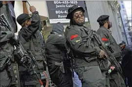  ?? Photograph­s by Marcus Yam Los Angeles Times ?? BLACK PANTHERS join other gun rights activists at a rally in Richmond, Va. Boogaloo Bois cheered as they marched past, drawing taunts from Proud Boys.